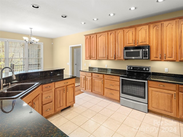 kitchen with sink, an inviting chandelier, decorative light fixtures, light tile patterned floors, and appliances with stainless steel finishes