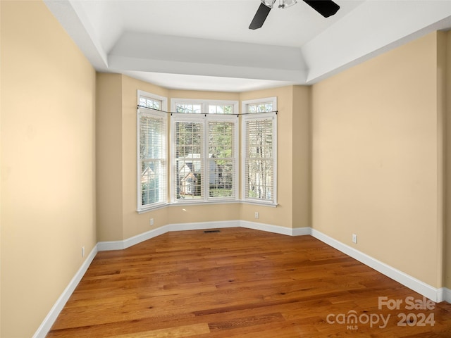 empty room with hardwood / wood-style floors and ceiling fan