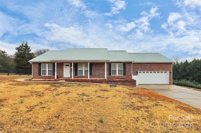 2945 Parks Lafferty Rd, Concord, NC 28025 - single story home with brick siding, driveway, a garage, and metal roof