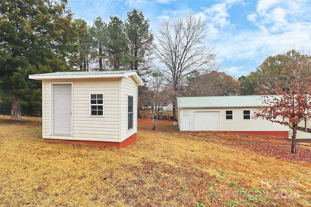 view of outdoor structure with a lawn and a garage