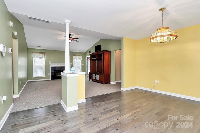 kitchen featuring ceiling fan, wood-type flooring, a fireplace, and vaulted ceiling