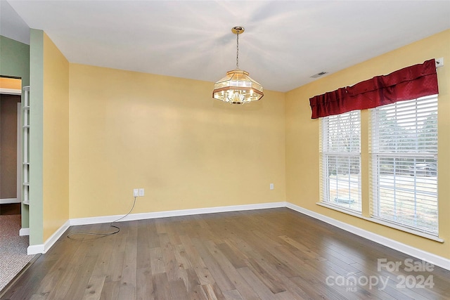 2945 Parks Lafferty Rd, Concord, NC 28025 - unfurnished room with wood finished floors, a chandelier, and baseboards