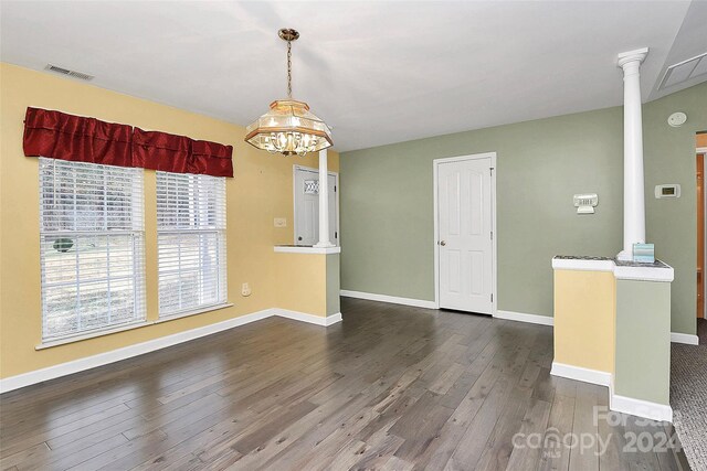 2945 Parks Lafferty Rd, Concord, NC 28025 - unfurnished room featuring ornate columns, dark wood finished floors, a chandelier, baseboards, and a smoke detector