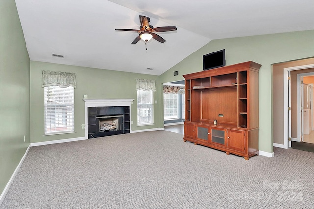 unfurnished living room with ceiling fan, a fireplace, carpet, and vaulted ceiling