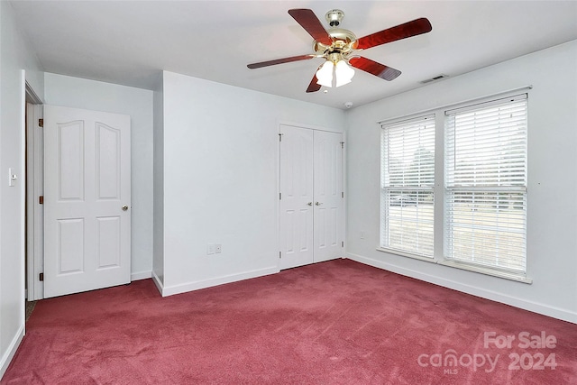 unfurnished bedroom featuring ceiling fan, a closet, and carpet