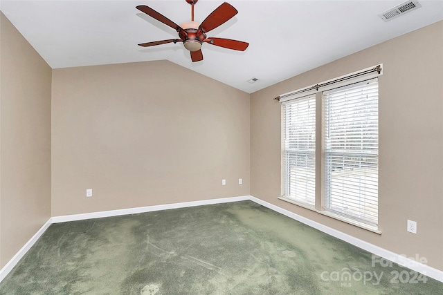 carpeted spare room with ceiling fan and vaulted ceiling