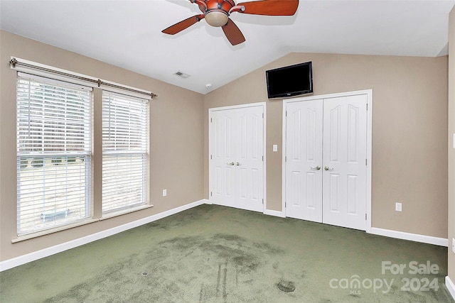 2945 Parks Lafferty Rd, Concord, NC 28025 - unfurnished bedroom featuring multiple closets, vaulted ceiling, carpet, multiple windows, and baseboards