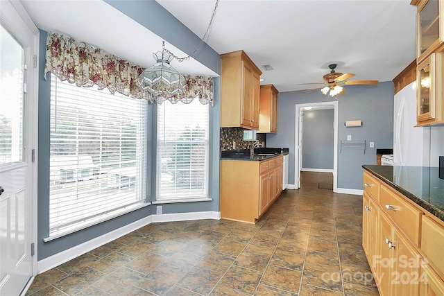 kitchen with plenty of natural light, backsplash, and hanging light fixtures