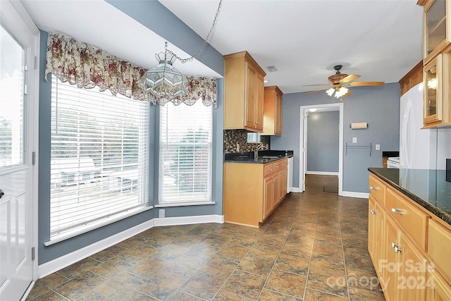 2945 Parks Lafferty Rd, Concord, NC 28025 - kitchen with a ceiling fan, glass insert cabinets, baseboards, a sink, and dark stone finish flooring
