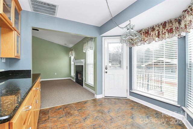 2945 Parks Lafferty Rd, Concord, NC 28025 - kitchen featuring a chandelier, glass insert cabinets, baseboards, and dark stone countertops