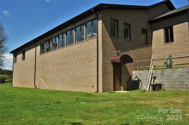 view of home's exterior with a yard