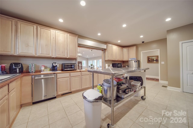 kitchen featuring dishwasher, light tile patterned flooring, and light brown cabinets