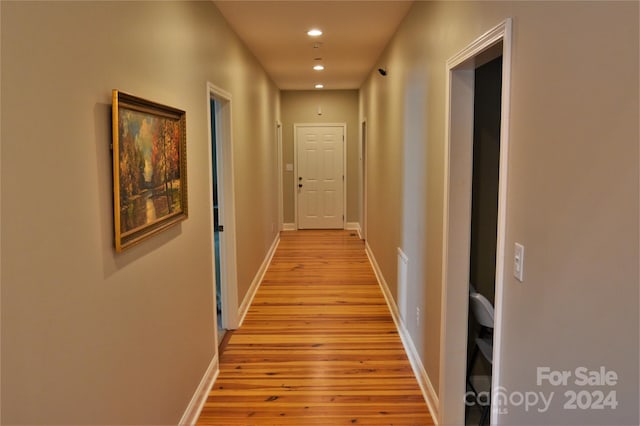 corridor with light wood-type flooring