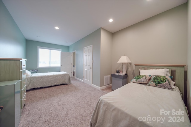 bedroom featuring light carpet