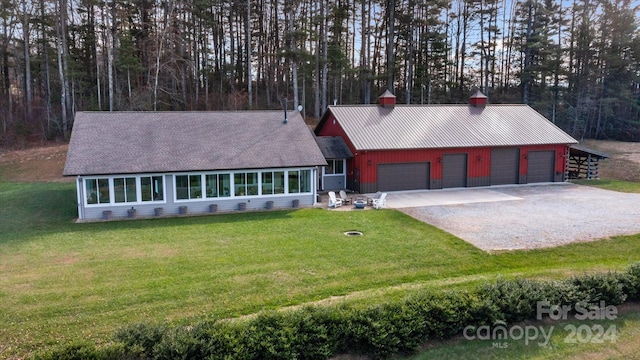 single story home featuring a garage and a front yard