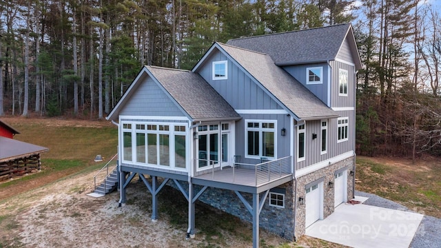 back of house featuring a garage and a sunroom