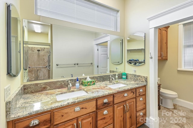 bathroom with tile patterned floors, toilet, vanity, and walk in shower