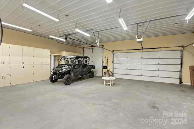 garage featuring a garage door opener and a carport