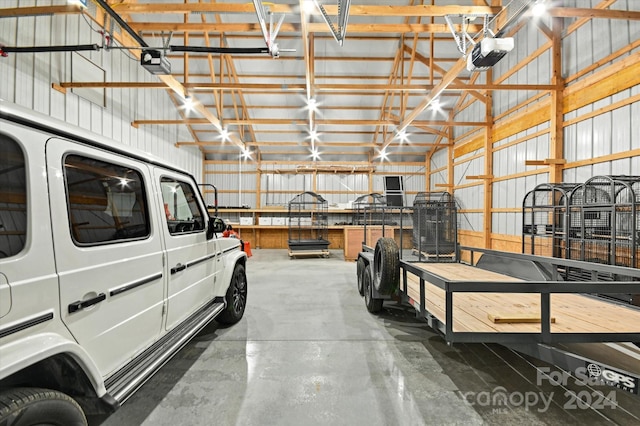 garage with a workshop area and a garage door opener