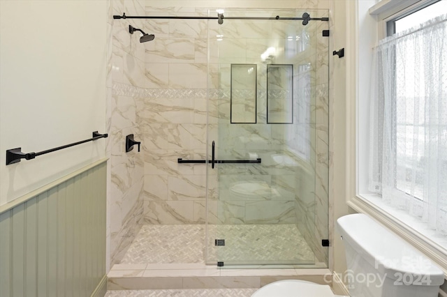 bathroom with tile patterned flooring, toilet, and walk in shower