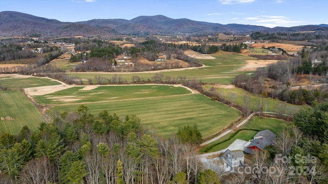 birds eye view of property with a mountain view