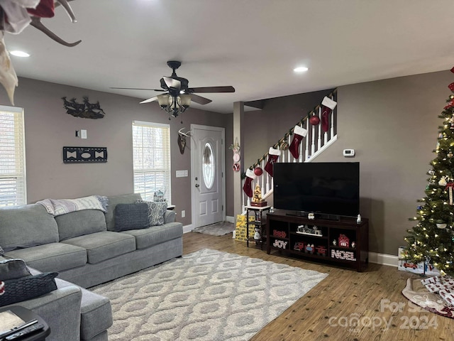 living room featuring hardwood / wood-style floors and ceiling fan