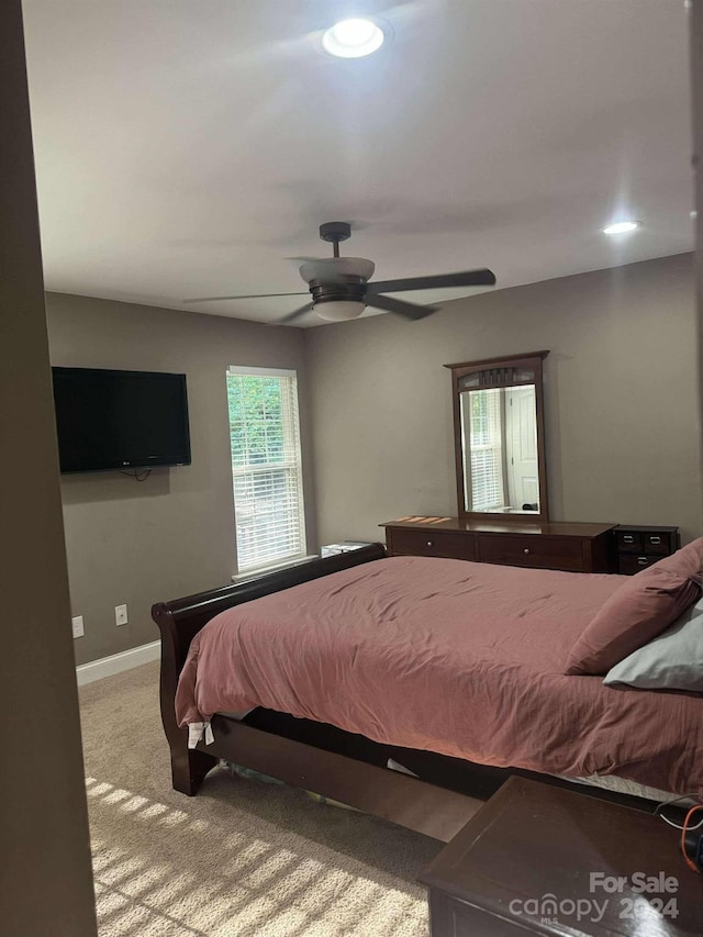 carpeted bedroom featuring ceiling fan