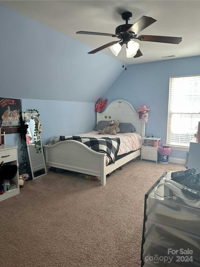 carpeted bedroom featuring ceiling fan and vaulted ceiling