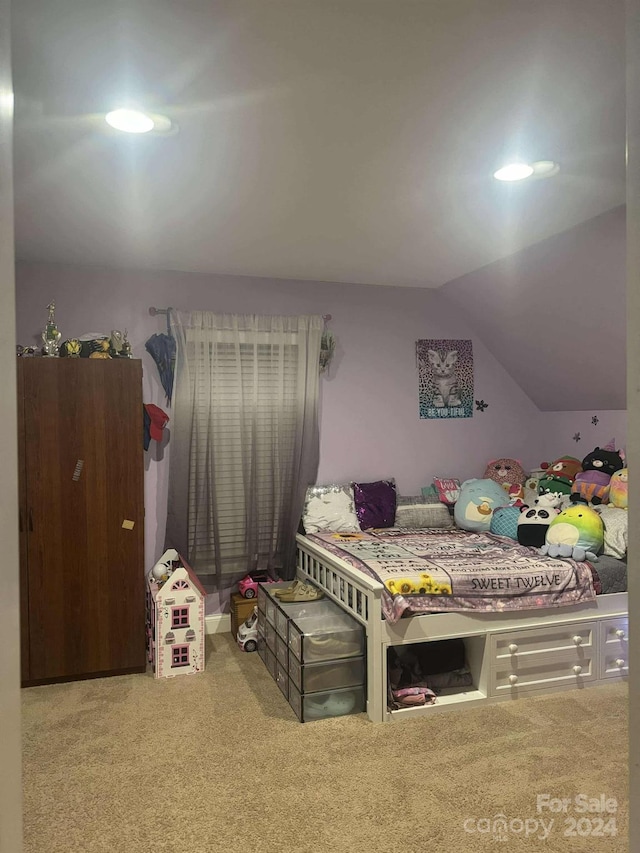 bedroom with carpet and vaulted ceiling