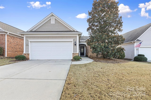 view of front facade with a garage and a front lawn