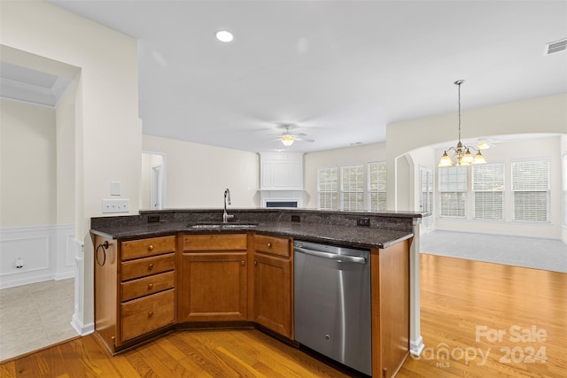 kitchen with light wood-type flooring, ceiling fan with notable chandelier, sink, decorative light fixtures, and dishwasher