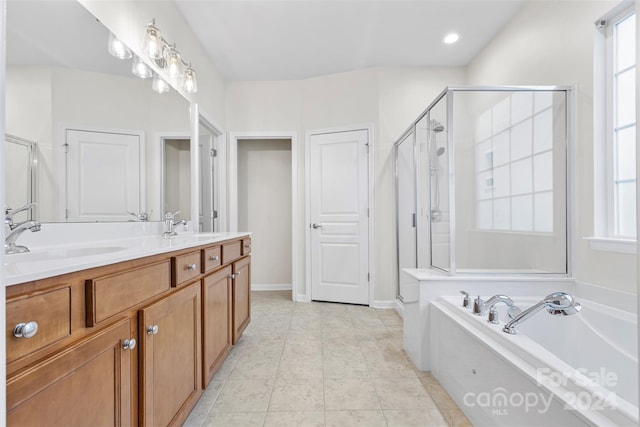 bathroom with shower with separate bathtub, vanity, and tile patterned floors