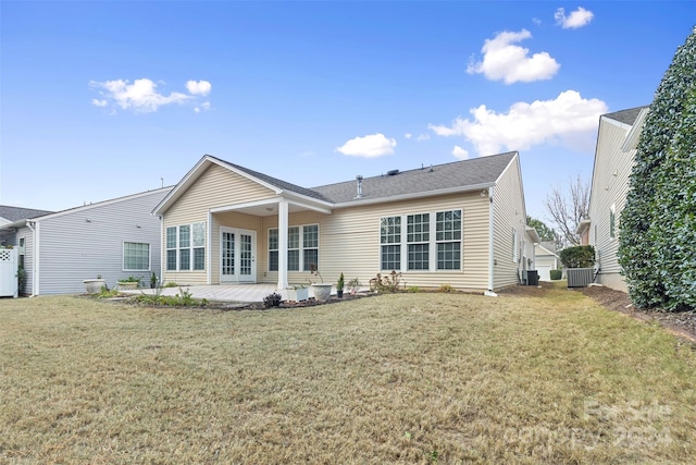 back of property with a patio area and a yard