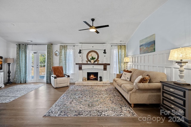 12128 Robins Nest Ln, Charlotte, NC 28269 - living room featuring a ceiling fan, a tiled fireplace, wood finished floors, a textured ceiling, and wainscoting