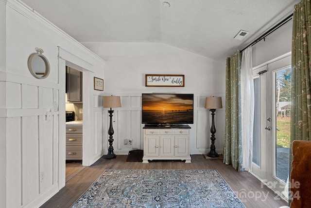 living room with dark wood-type flooring and lofted ceiling