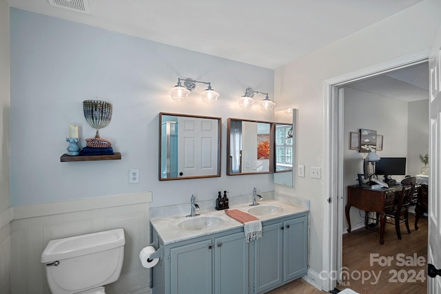 bathroom featuring toilet, vanity, and hardwood / wood-style flooring