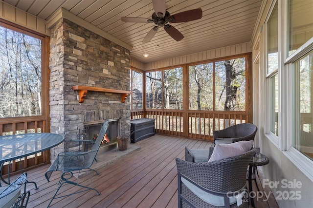 sunroom with wood ceiling and ceiling fan