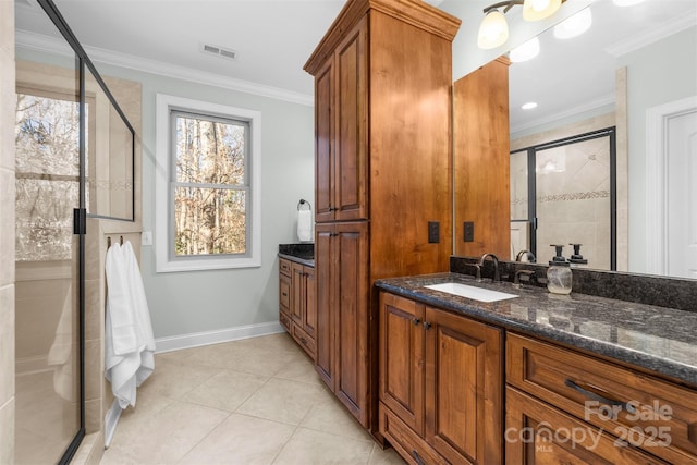 bathroom featuring tile patterned flooring, crown molding, vanity, and walk in shower