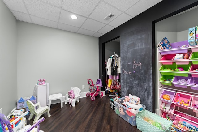 recreation room with a drop ceiling and hardwood / wood-style floors