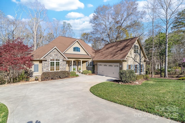 view of front of property featuring a front yard, stone siding, concrete driveway, stucco siding, and an attached garage
