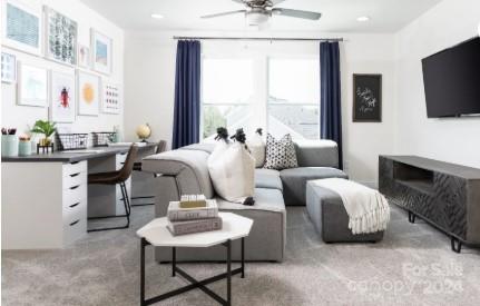 carpeted living room featuring ceiling fan