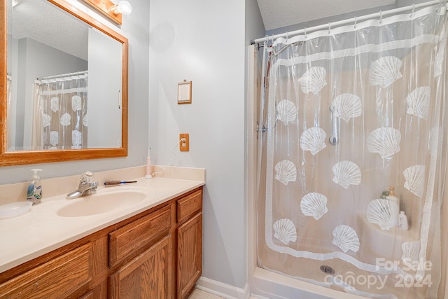 bathroom with a shower with shower curtain, vanity, and a textured ceiling