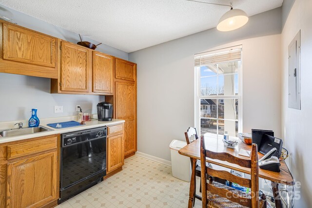 kitchen with electric panel, sink, black dishwasher, and a textured ceiling