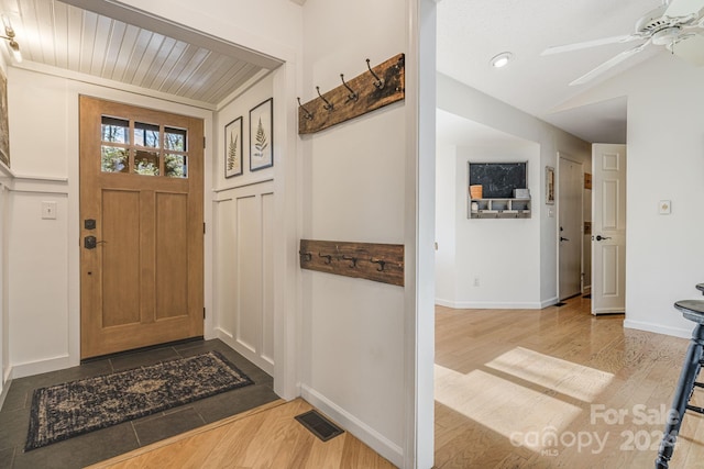 foyer featuring ceiling fan, light hardwood / wood-style floors, and wooden ceiling