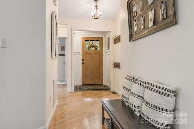 interior space featuring light hardwood / wood-style floors and a notable chandelier