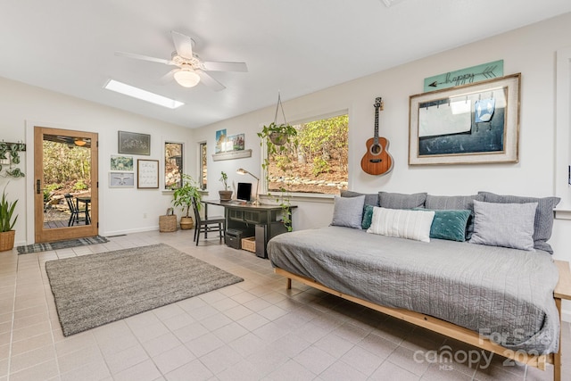 tiled living room featuring ceiling fan, plenty of natural light, and vaulted ceiling