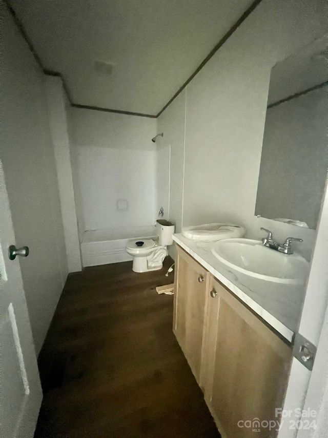 full bathroom with wood-type flooring, vanity, shower / bath combination, and toilet