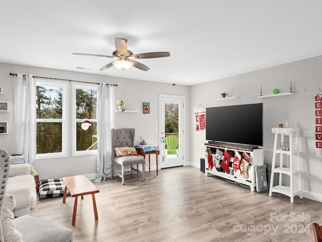 living room featuring ceiling fan and wood-type flooring