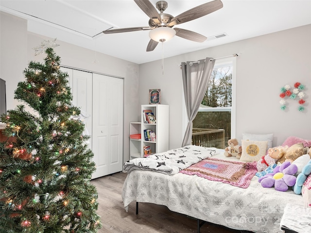 bedroom featuring ceiling fan, a closet, and light wood-type flooring