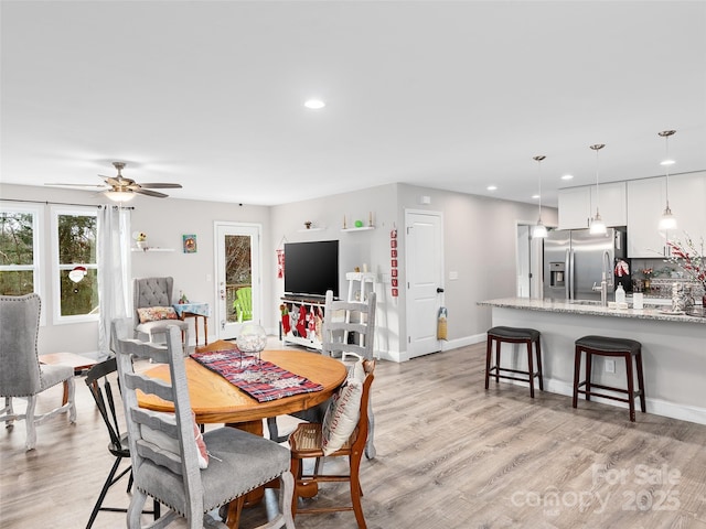 dining room with recessed lighting, ceiling fan, baseboards, and light wood-style floors